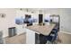 Bright kitchen with white cabinets, stainless steel appliances, granite countertops and blue subway tile backsplash at 1185 Catskill Dr, Haines City, FL 33844