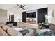 Modern living room with decorative paneling, flat screen tv, floating console and sectional couch at 1185 Catskill Dr, Haines City, FL 33844