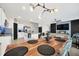 Open-concept living area with a dining table, kitchen, and modern decor, creating a welcoming atmosphere at 1185 Catskill Dr, Haines City, FL 33844