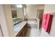 Bright bathroom with a soaking tub, walk-in shower, dual sinks, and generous counter space at 14112 Queenside St, Orlando, FL 32824