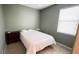 Minimalist bedroom features a bed, dresser, and window for natural light at 14112 Queenside St, Orlando, FL 32824