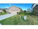 Well-maintained home with lush green lawn and attractive landscaping at 14112 Queenside St, Orlando, FL 32824