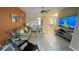 Open concept living room with tile floors, modern furnishings and great natural light at 14112 Queenside St, Orlando, FL 32824
