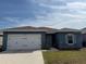 Charming single-story home featuring a two-car garage and well-maintained lawn at 1629 Ambar Ct, Winter Haven, FL 33881