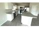 Bright kitchen with white cabinetry, stainless steel appliances and center island at 1629 Ambar Ct, Winter Haven, FL 33881