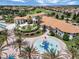 Capture the essence of luxury living in this aerial view of a resort featuring a sprawling pool and lush landscaping at 1646 Moon Valley Dr, Davenport, FL 33896