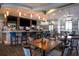 A stylish bar area boasts comfortable seating, modern lighting, and a fully stocked counter for enjoyable gatherings at 1646 Moon Valley Dr, Davenport, FL 33896