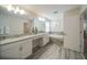 Large bathroom with double vanity, granite countertops, soaking tub, and stylish tile flooring at 1646 Moon Valley Dr, Davenport, FL 33896