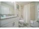 Cozy bathroom featuring a shower-tub combo, white vanity with granite top, and stylish gray floors at 1646 Moon Valley Dr, Davenport, FL 33896