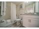Cozy bathroom featuring a shower-tub combo, white vanity with granite top, and stylish gray floors at 1646 Moon Valley Dr, Davenport, FL 33896