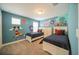 Bright bedroom featuring twin beds, soft carpet and a playful cartoon wall decor at 1646 Moon Valley Dr, Davenport, FL 33896