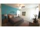 Comfortable bedroom featuring a queen-size bed, soft carpet and a serene turquoise accent wall at 1646 Moon Valley Dr, Davenport, FL 33896