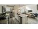 Modern kitchen featuring white cabinetry, stainless steel appliances, granite counters and luxury vinyl plank flooring at 1646 Moon Valley Dr, Davenport, FL 33896
