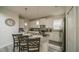 Modern kitchen featuring white cabinetry, stainless steel appliances, pendant lighting, and an eat-in island at 1646 Moon Valley Dr, Davenport, FL 33896