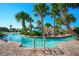 Community pool featuring palm trees, clear blue water, stone pavers and a winding water slide at 1646 Moon Valley Dr, Davenport, FL 33896