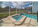 Screened-in pool area with a spa and plenty of space for lounging at 1646 Moon Valley Dr, Davenport, FL 33896