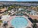Large community pool with many chairs and umbrellas at 1646 Moon Valley Dr, Davenport, FL 33896