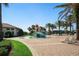 Community splash pad with water features, lounge chairs, and tropical landscaping at 1646 Moon Valley Dr, Davenport, FL 33896