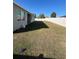 Expansive backyard with a well-maintained lawn and a white privacy fence in a sunny setting at 1664 Redfin Dr, Kissimmee, FL 34759