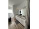 Bathroom features a double sink vanity with granite countertops at 1664 Redfin Dr, Kissimmee, FL 34759