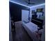 This bedroom includes decorative lighting, a ceiling fan, and a dark accent wall at 1664 Redfin Dr, Kissimmee, FL 34759