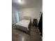 Cozy bedroom featuring wood-look flooring and a neutral color palette at 1664 Redfin Dr, Kissimmee, FL 34759