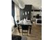Dining area with black table set and views of the kitchen, complimented by a unique light fixture at 1664 Redfin Dr, Kissimmee, FL 34759
