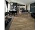 Open concept living room and kitchen, with black dining set and modern lighting at 1664 Redfin Dr, Kissimmee, FL 34759