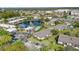 Birds eye view shows the lake, condos, community pool, parking areas, and landscaping of the community at 1695 Lee Rd # E103, Winter Park, FL 32789