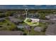 Aerial image of condo buildings, parking, green spaces, a pool, and lake with highlighted building at 1695 Lee Rd # E103, Winter Park, FL 32789