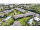 An aerial view of condo buildings with green spaces, parking, and a pool area for residents to enjoy at 1695 Lee Rd # E103, Winter Park, FL 32789