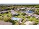 Aerial view showcases a community with a pool, clubhouse, and a scenic pond with a fountain at 1695 Lee Rd # E103, Winter Park, FL 32789