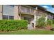 Private outdoor patio with a sliding glass door, wooden bench and lush landscaping at 1695 Lee Rd # E103, Winter Park, FL 32789