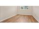 An empty bedroom showcases hardwood floors and a window that provides natural light, creating a calm space at 1695 Lee Rd # E103, Winter Park, FL 32789