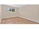 Empty bedroom with hardwood floors, a window, neutral paint, and bright natural light at 1695 Lee Rd # E103, Winter Park, FL 32789