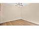 Empty bedroom featuring hardwood floors, a ceiling fan, and neutral paint at 1695 Lee Rd # E103, Winter Park, FL 32789