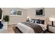 This bright bedroom has a large window, sleek nightstands, and a bed with stylish pillows and blankets at 1695 Lee Rd # E103, Winter Park, FL 32789