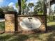 Stone sign for Waterfall Cove at Winter Park with tropical landscaping in the background at 1695 Lee Rd # E103, Winter Park, FL 32789