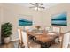 A well-lit dining room features a wood table set for six and modern artwork to enhance the elegant space at 1695 Lee Rd # E103, Winter Park, FL 32789