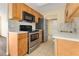 Efficient kitchen with stainless steel appliances and ample wood cabinetry at 1695 Lee Rd # E103, Winter Park, FL 32789