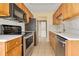 Efficient kitchen with stainless steel appliances and ample wood cabinetry at 1695 Lee Rd # E103, Winter Park, FL 32789