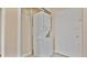 Bright laundry room with stacked washer and dryer, and a door for easy access at 1695 Lee Rd # E103, Winter Park, FL 32789