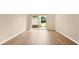 Unfurnished living room with wood floors, a sliding glass door to a small patio at 1695 Lee Rd # E103, Winter Park, FL 32789