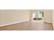 Bright living room with wood floors and sliding glass doors to a patio area at 1695 Lee Rd # E103, Winter Park, FL 32789