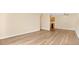 Unfurnished living room with wood floors open to a kitchen area at 1695 Lee Rd # E103, Winter Park, FL 32789