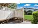 Cozy outdoor patio with a built-in bench and a view of the lush green lawn at 1695 Lee Rd # E103, Winter Park, FL 32789