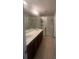 Modern bathroom features double vanity, framed mirrors, and walk-in shower at 1749 Fulfillment Dr, Kissimmee, FL 34744