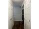 Upper level hallway with wood floors and doors leads to additional rooms at 1749 Fulfillment Dr, Kissimmee, FL 34744
