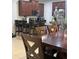 Kitchen and Dining area featuring dark wood cabinetry, stainless appliances, and a breakfast bar at 1749 Fulfillment Dr, Kissimmee, FL 34744