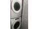 Laundry room features stacked washer and dryer and adjacent storage at 1749 Fulfillment Dr, Kissimmee, FL 34744